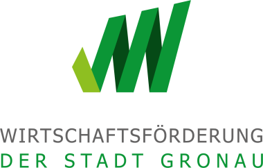 Logo der Wirtschaftsförderung der Stadt Gronau mit einem stilisierten grünen „W“ in verschiedenen Grüntönen. Unter dem Symbol steht der Schriftzug „Wirtschaftsförderung der Stadt Gronau“.
